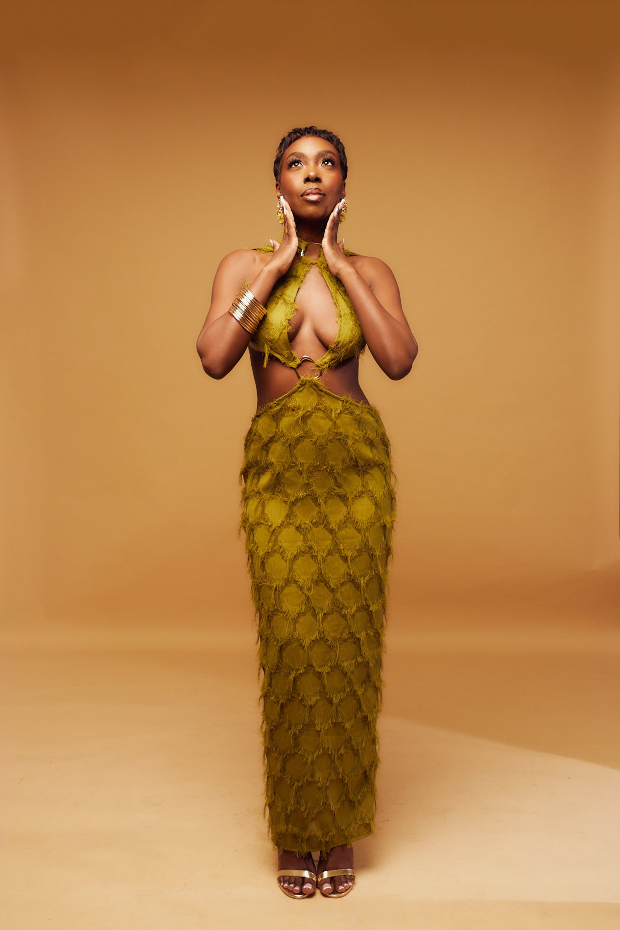 Cleonie McLean in an olive-gold editorial gown
